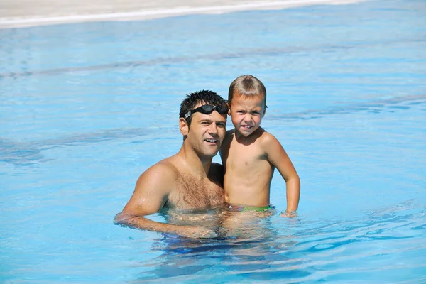 happy father and son in swimming pool