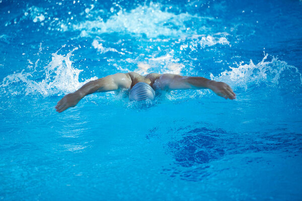 swimmer exercise on indoor swimming pool