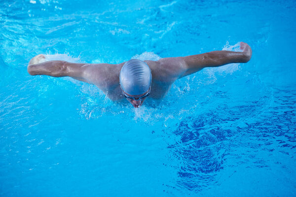 swimmer exercise on indoor swimming pool