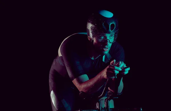 夜は速く自転車に乗るトライアスロン選手 — ストック写真