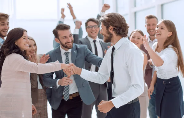 happy group of employees congratulating their leader