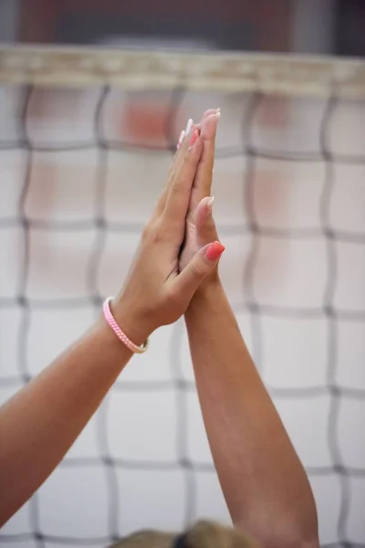volleyball team giving high five