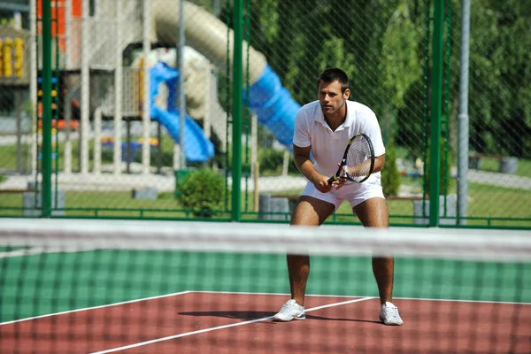 Young Man Play Tennis Outdoor Stock Photo