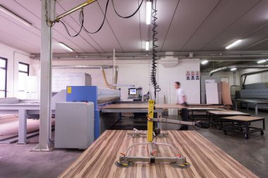 worker in a factory of wooden furniture