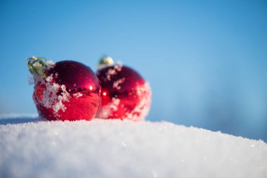 Taze karda kırmızı Noel topları. Kış tatili uygun.