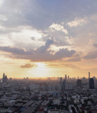Gorgeous panorama scenic of the sunrise or sunset with cloud on the orange and blue sky over large metropolitan city in Bangkok. 