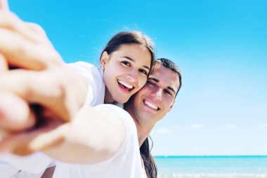 happy couple have fun on the beach