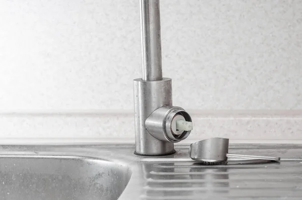 Broken faucet handle in the kitchen sink