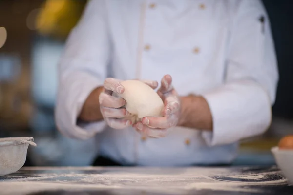 chef hands preparing dough for pizza