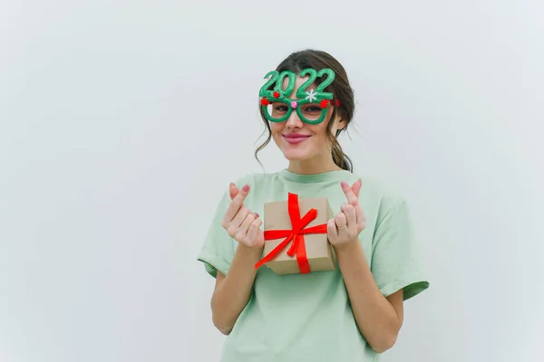 Modern Young Woman Wearing 2022 Glasses Holding Christmas Present Showing — Stock Photo, Image