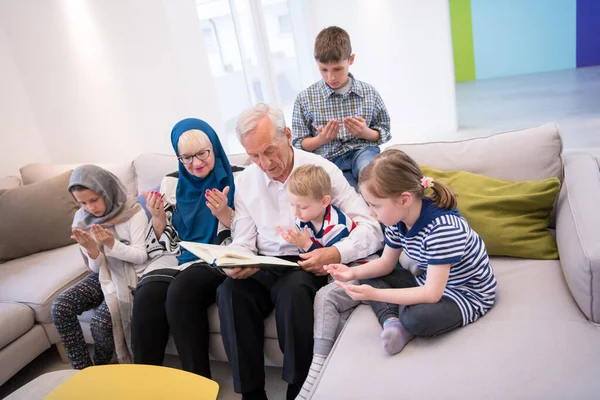 modern muslim grandparents with grandchildren reading Quran
