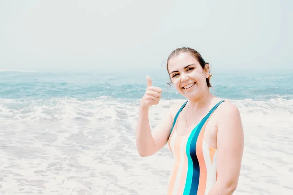 Young Woman Swimsuit Salutes Camera Sunny Day Beach Ocean Background — Fotografia de Stock