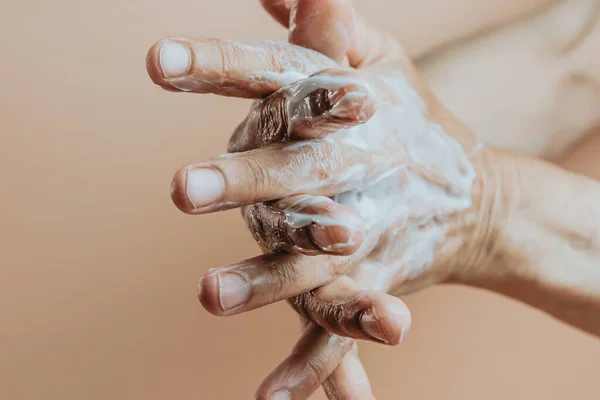 Elderly Woman Rubbing Hand Cream Close Minimal Pastel Background Copy — Foto de Stock