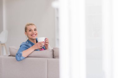 Bir fincan kahve içen bir kadın.