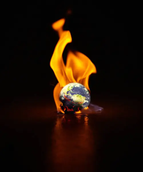 Shot of the earth engulfed in flames against a black background.