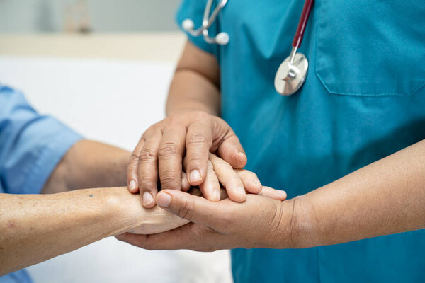"Holding hands Asian senior or elderly old lady woman patient with love, care, encourage and empathy at nursing hospital ward, healthy strong medical concept"