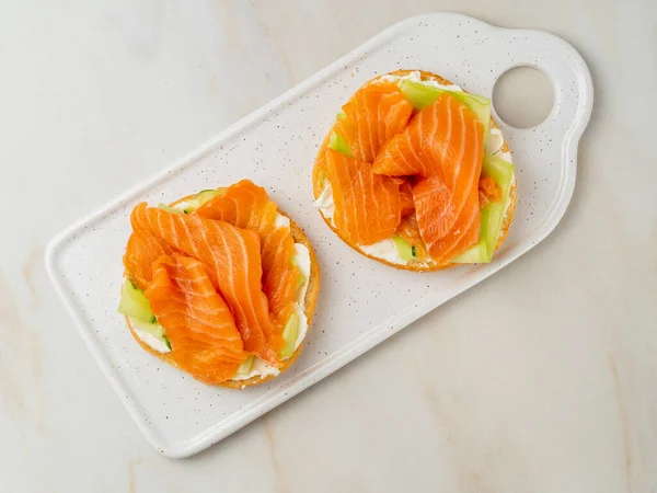 Two Open Sandwiches Salmon Cream Cheese Cucumber Slices White Marble — Stock Photo, Image