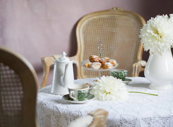 tea break in English style, vintage still life, homemade buns, a bouquet dalias