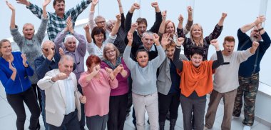 group of mature friends raised their hands up and celebrate  clipart