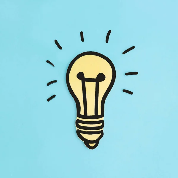 Illuminated Paper Cutout Yellow Light Bulb Blue Background — Stock Photo, Image