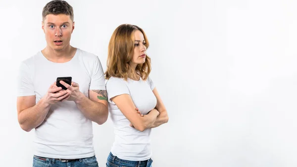 Shocked Man Holding Mobile Phone Hand Standing Her Angry Girlfriend — Stock Photo, Image