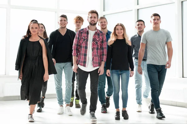 stock image group of diverse young people walking in a new office