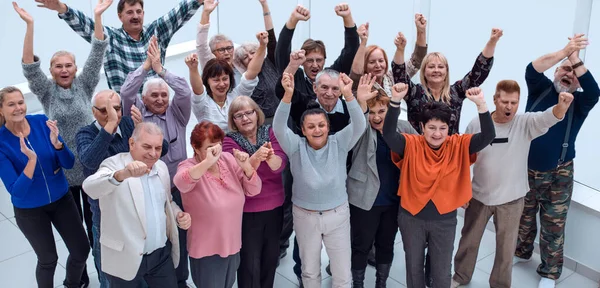 stock image group of mature friends raised their hands up and celebrate 