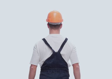 Dikiz aynası. Çalışma kıyafetli bir adam mekanın bir kopyasına bakıyor.