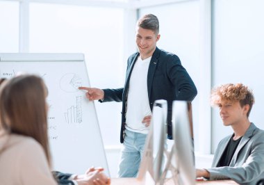 young businessman making a report at a meeting with the business team