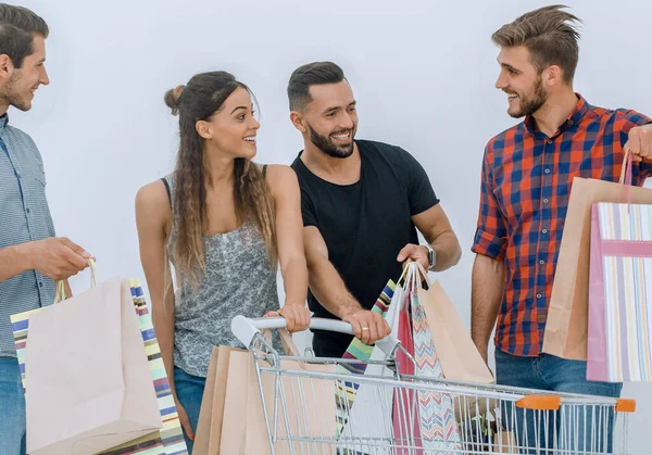 stock image group of young people discussing their purchases
