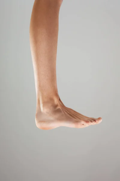 Sexy Female Legs Gray Background — Zdjęcie stockowe