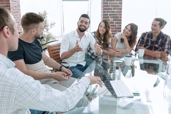 stock image business team sitting at a modern Desk.