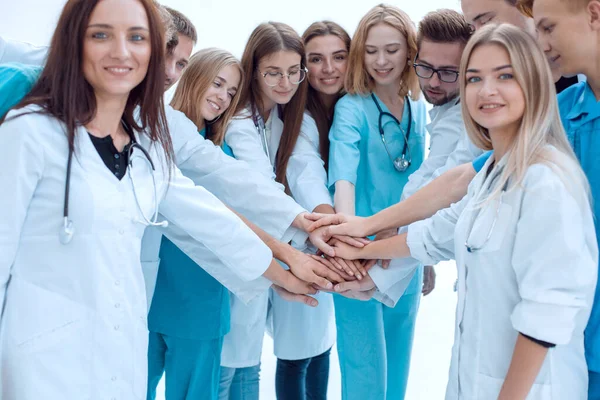 close up. a group of medical professionals putting their hands together