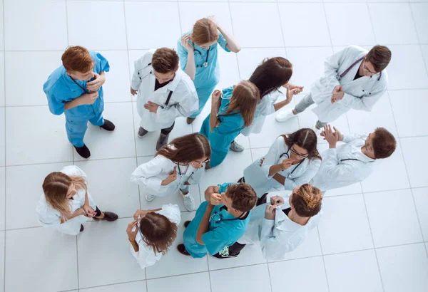 young doctor standing in front of a group of interns, top view