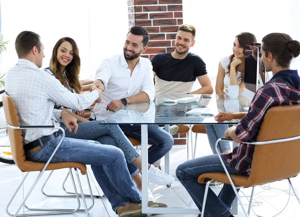 stock image handshake of business partners sitting at the table