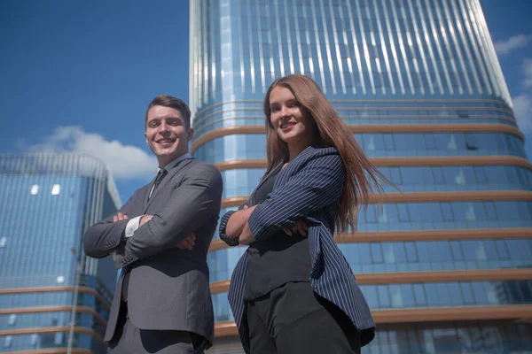 two confident young leaders on the background of an office building