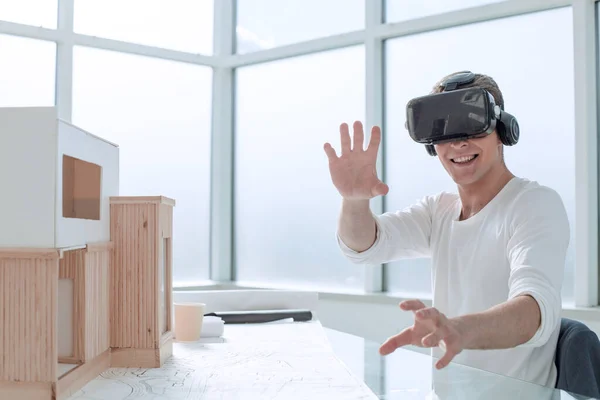 close up. smiling designer in a virtual reality helmet.