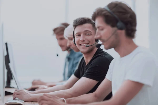 group of people in the headset works on personal computers.