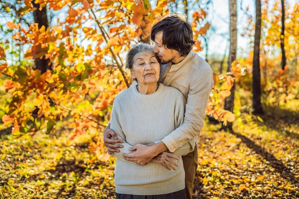 Grandmother Adult Grandson Hugging Autumn Park — Stock Photo, Image