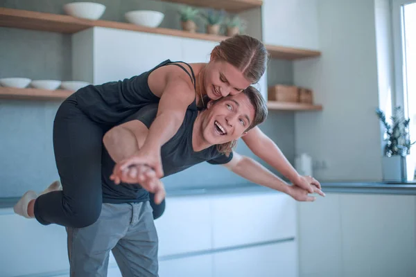 stock image loving young couple having fun in their kitchen.