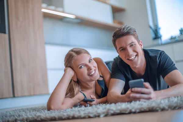 Happy Young Family Lying Floor Looking Camera — Stock Photo, Image