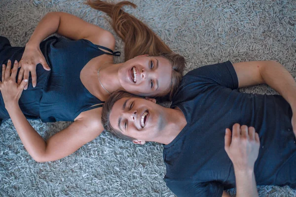Happy Young Couple Lying Carpet Looking Camera — Stock Photo, Image