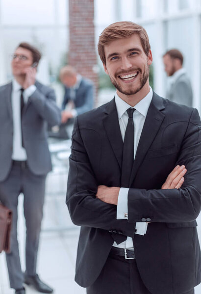 smiling business man standing in a modern office
