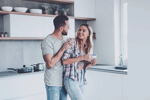 cheerful couple in the kitchen on a good morning