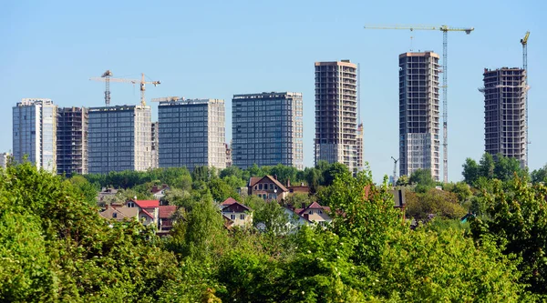 green spaces against the background of the construction of multi-storey buildings, trees, park.