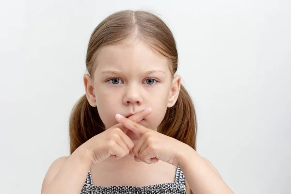 Serious Child Crossed Fingers Mouth — Stockfoto