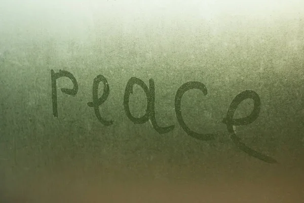 Inscription Peace Wet Glass Closeup — Stok fotoğraf