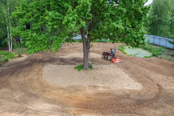 Farmer Mini Tractor Loosens Soil Lawn Land Cultivation Surface Leveling — Zdjęcie stockowe
