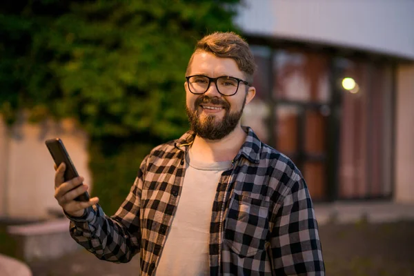 Bearded Man Wearing Eyeglasses Holding Scrolling Texting His Cellphone Night — Stock Fotó