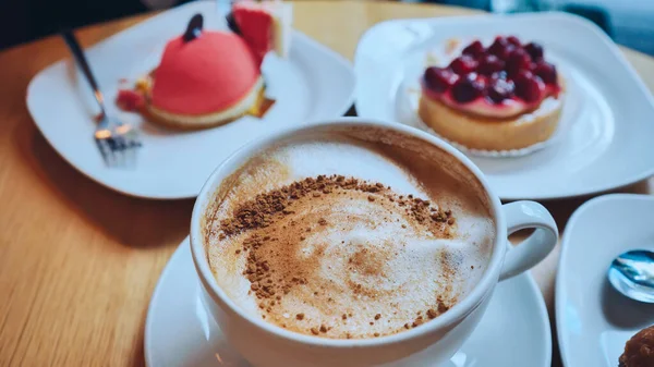 A table of cakes and coffee at a girl\'s breakfast.